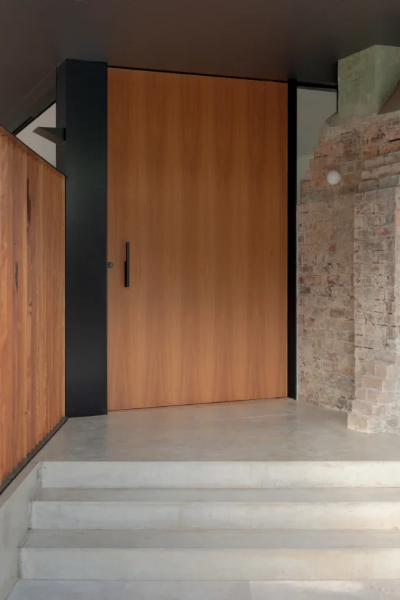 Timber pivot front door with exposed original brickwork at Pymble cottage renovation