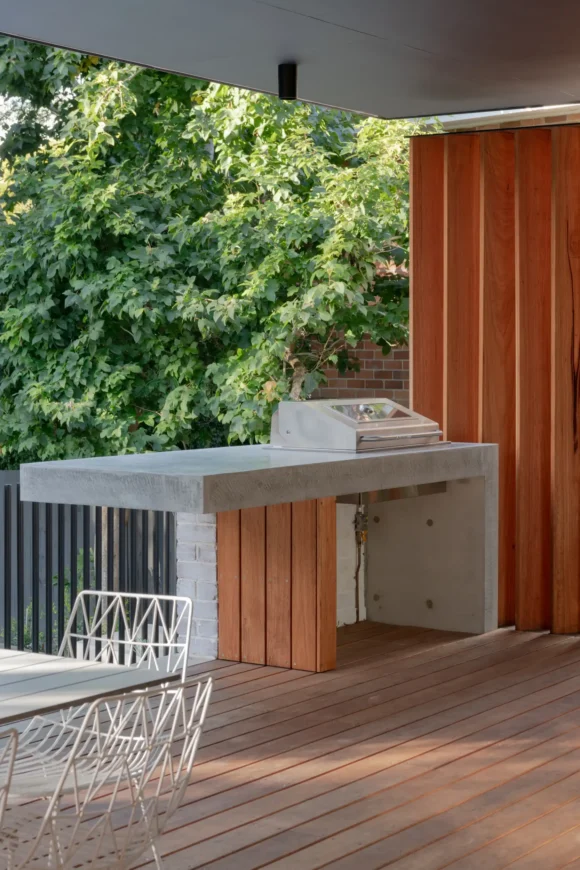 Built-in concrete BBQ centrepiece on hardwood deck under cantilevered awning – Pymble outdoor entertaining zone